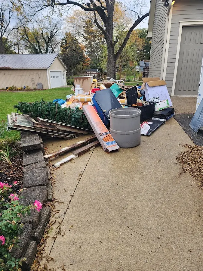 Dumpster being loaded with debris for Roofing Dumpster Rental in Littleton